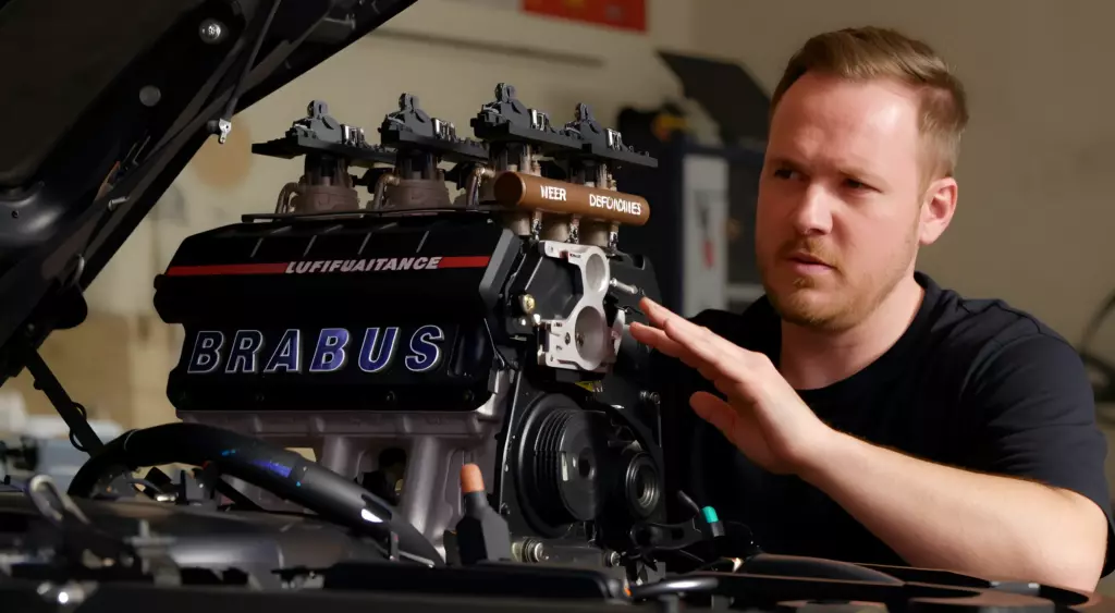 A realistic photo of a mechanic's hands working on a car engine in a workshop, with tools and engine parts visible, captured in a horizontal orientation
